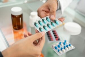 pharmacist handing patient drugs
