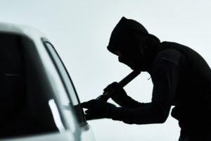 burglar trying to break into a car