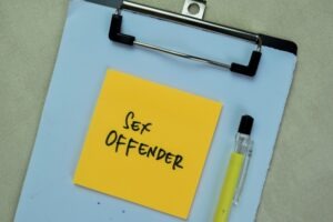 The word “sex offender” written on a clipboard. What is a level 1 sex offender in Arizona?