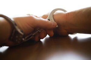 A police officer handcuffing a level 2 sex offender in Arizona.