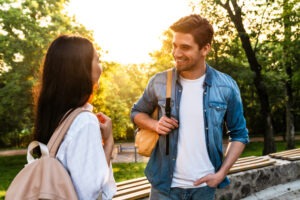 A male student chatting with a female student. Learn about the legal age of consent in Arizona.