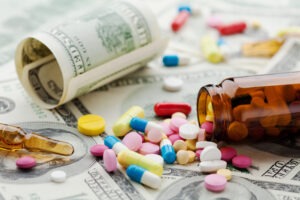 Colorful pills spill out over hundred-dollar bills to symbolize the way the feds build a drug case.