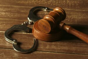 A judge’s gavel and handcuffs in a Phoenix violent crime charges case