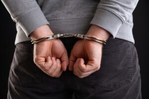 A person in handcuffs representing someone facing criminal charges in Tucson.
