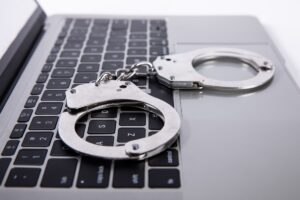 Handcuffs on a computer keyboard in a Phoenix child pornography case.