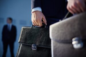 Questions to ask before hiring a lawyer in Phoenix, illustrated with a lawyer carrying a briefcase