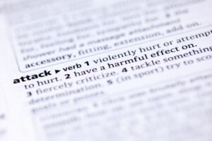 A page showing the definition of the word “attack” to symbolize the question of what simple assault is in Arizona.