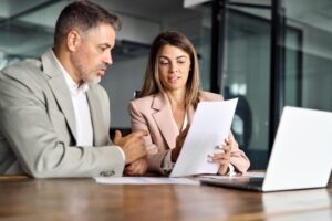 A lawyer reviewing common types of white collar crime with a client.